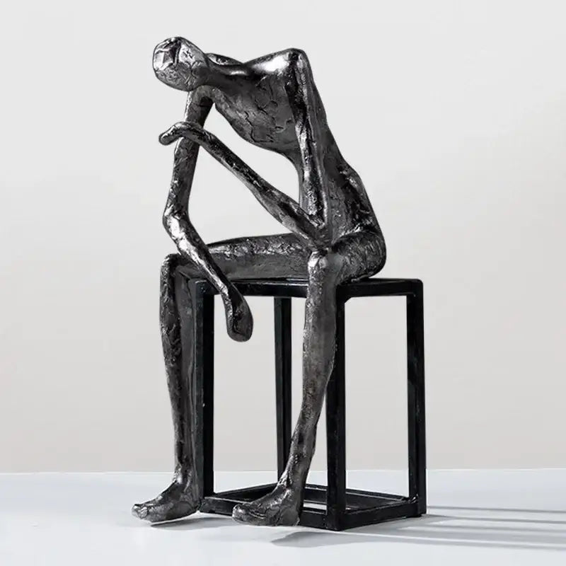 Modern oxidized silver abstract thinkers sculpture by decorbites featuring a contemplative figure on black cube stool