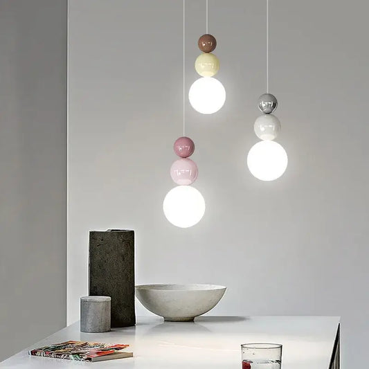 Modern pendant light with stacked spherical glass shades in muted pastel and cream metal light color options for dining room