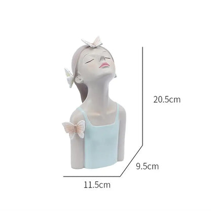 A serene light blue and white resin butterfly girl sculpture with closed eyes and delicate butterfly accents for decor