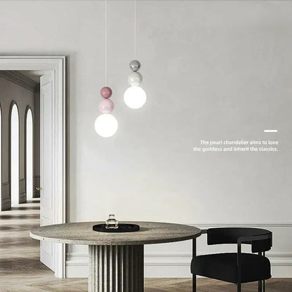 Modern pendant light with spherical white pink and silver glass globes hanging from thin cords for bedroom decorbites cream nordic led lighting