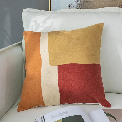 Modern pastel geometric cushion cover with embroidered orange, mustard yellow, and terracotta decorbites geometric cushion design