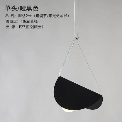 Black matte geometric iron pendant light with minimalist semi-circular shade and thin white cords for dining room decorbites geometric iron