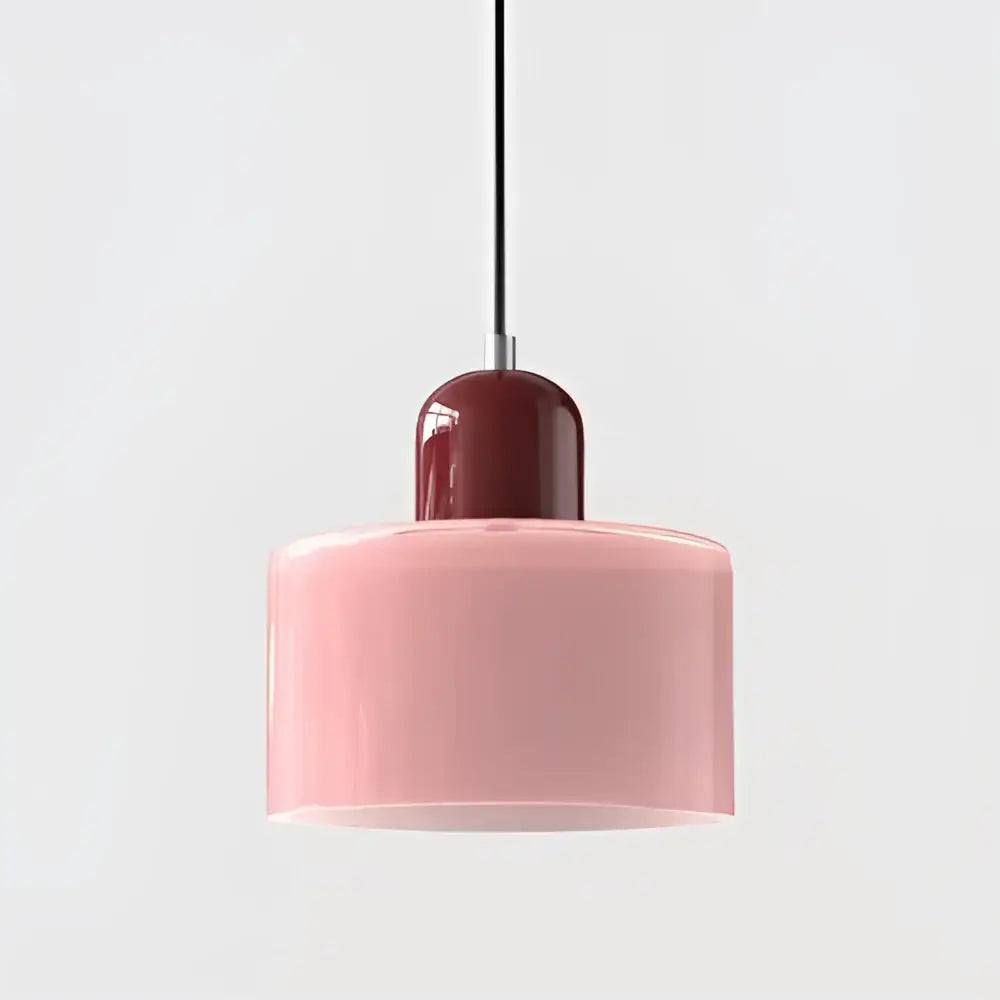 Modern pendant light with soft pink glass shade and glossy burgundy top cap suspended by black cord for kitchen use