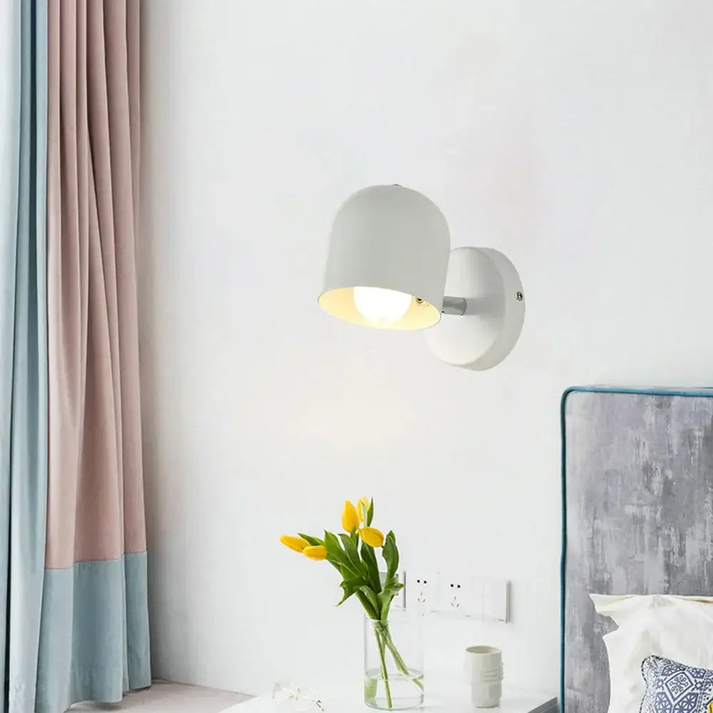 Modern pastel matte iron wall light fixture with a white matte dome-shaped shade ideal for bedroom lighting