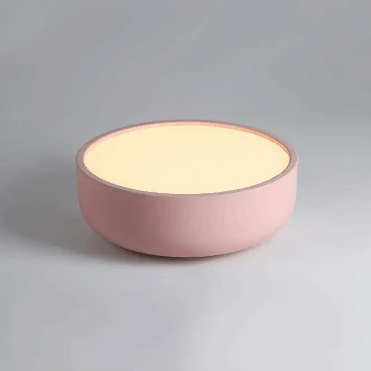 A soft pink round table lamp with matte finish and warm glow complements modern pastel pink and teal decorbites circular led ceiling light