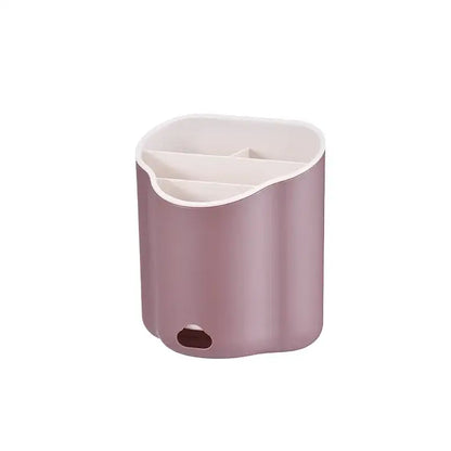 A sleek matte rose gold plastic double layer cutlery holder with white interior and three compartments for kitchen organization
