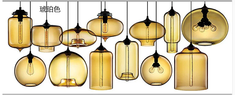 Modern pendant lights featuring amber-tinted glass and black metal fixtures with exposed filament bulbs for bedroom and dining room decor