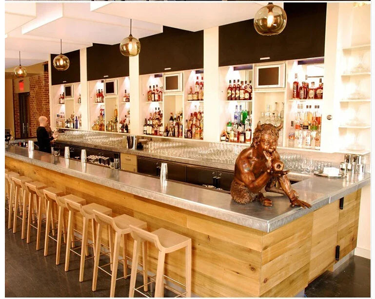 Bronze devil figurine on bar counter with multicolored glass modern pendant lights for bedroom and dining room decor