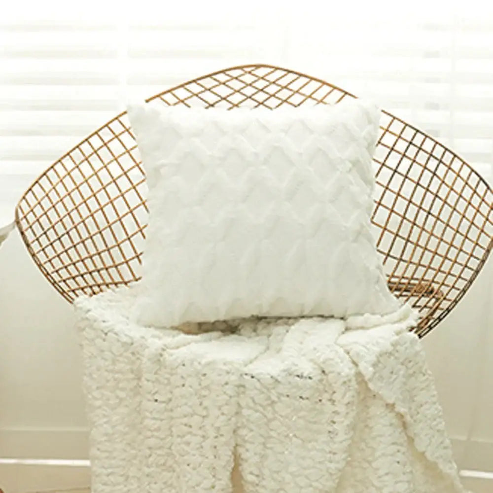 White textured cushion cover with quilted diamond embroidery resting on wire chair for modern living room decor