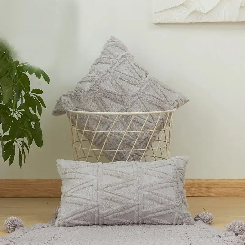 Gray textured throw pillow with geometric pattern and tassel trim as a modern embroidery cushion cover for living room