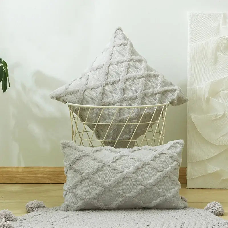 A soft light gray embroidery cushion cover with diamond pattern and tassel trim for modern living room decor