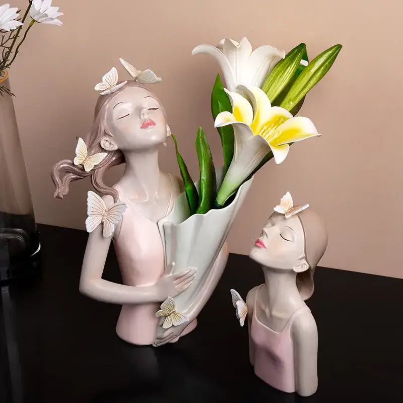 Delicate pink and white butterfly girl resin figure holding lilies with butterfly embellishments on gold tray decor