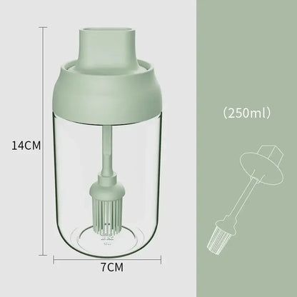 A 250ml transparent glass seasoning bottle with matte sage green lid and internal brush for easy pouring or dipping