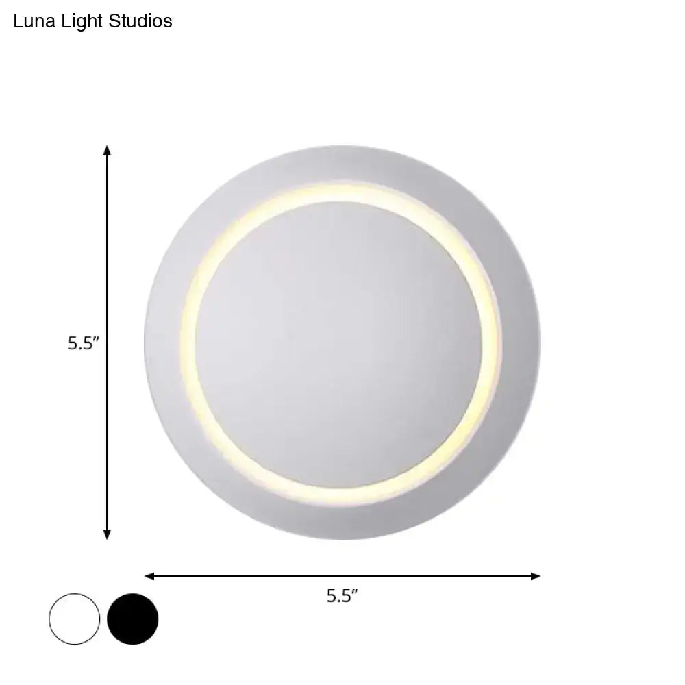 Circular ceiling light with a sleek white matte finish and an illuminated ring of warm led lighting.