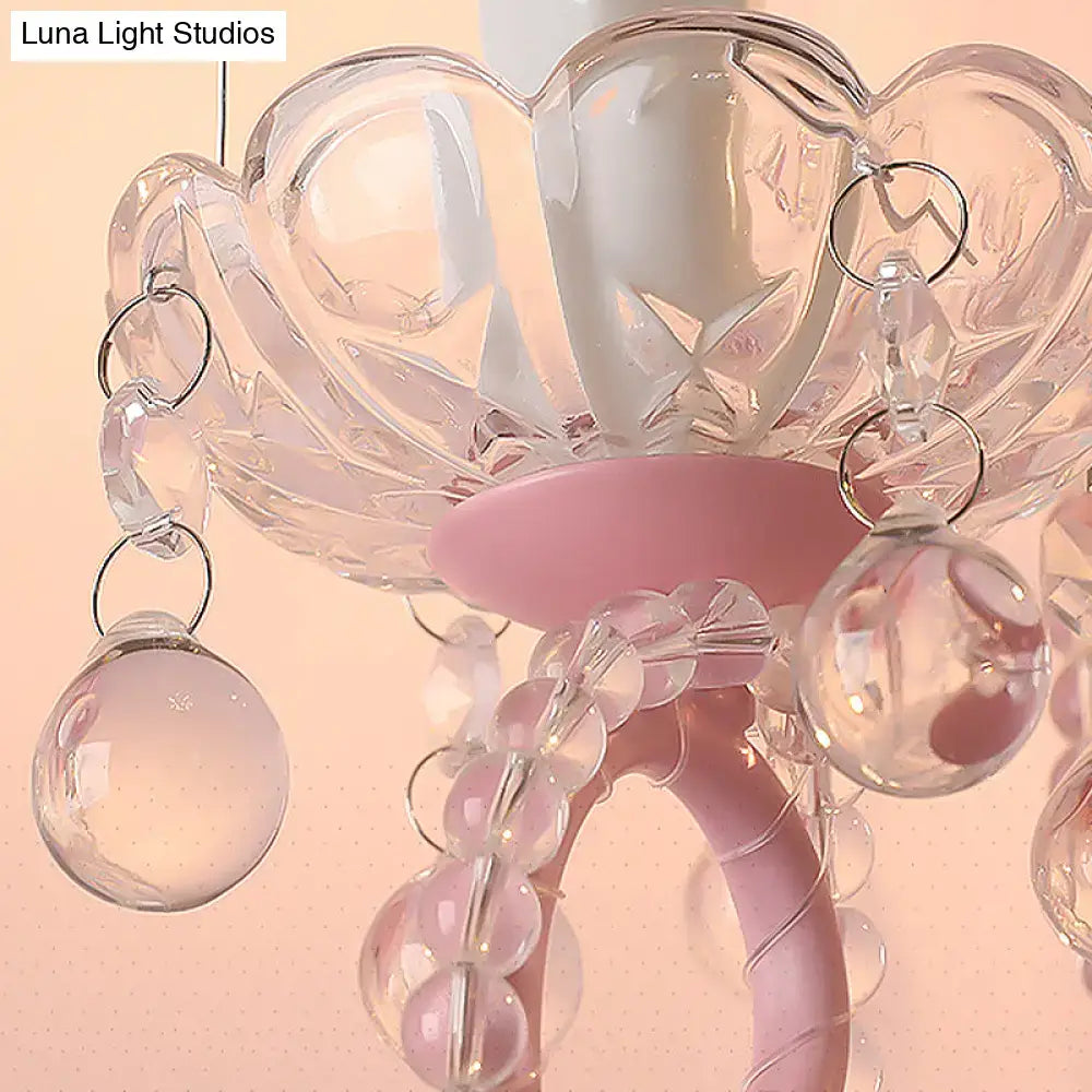Modern pink metallic scroll arm wall lamp with crystal bedroom sconce featuring a delicate pink and clear crystal chandelier