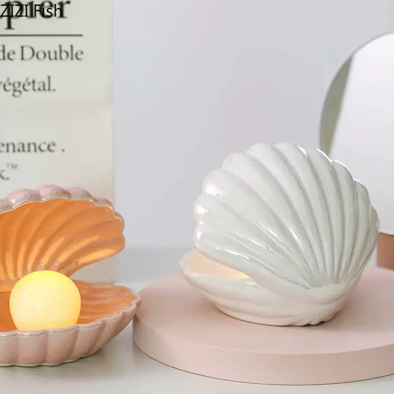 White ceramic seashell-shaped lamp desk decoration with soft inner glow for modern bedroom ambiance