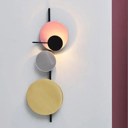 Modern pink silver and gold led wall lamp with three stacked circular discs on black rod for bedroom decor