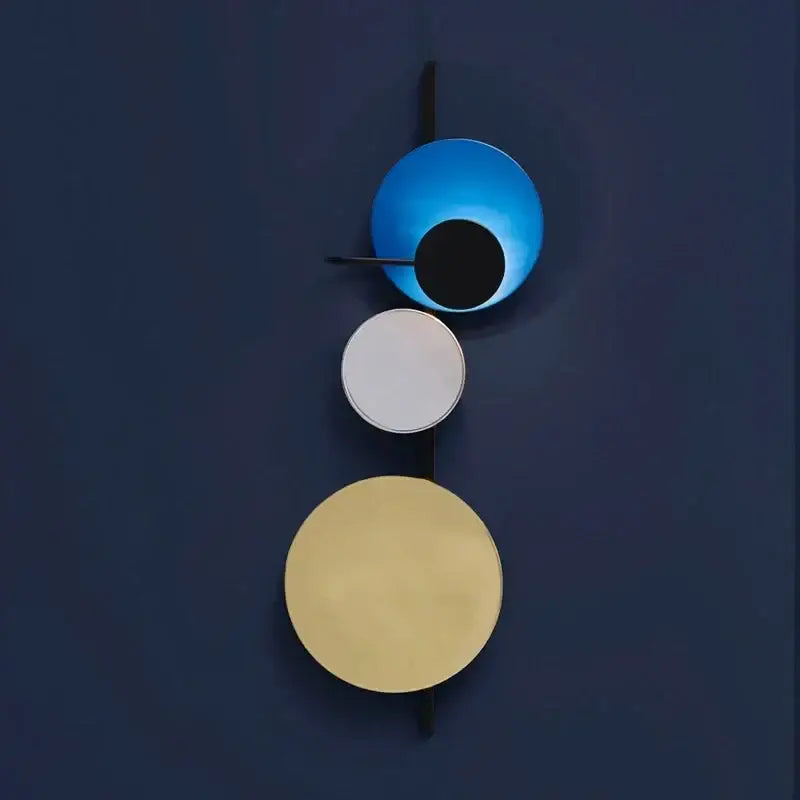 Modern pink silver and gold led wall lamp with three stacked circular shades in blue white and gold for bedroom decor