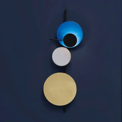 Modern pink silver and gold led wall lamp with three stacked circular shades in blue white and gold for bedroom decor