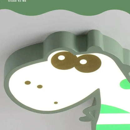 Modern pink and white decorbites dino led ceiling lamp with a soft green crocodile shape and gold-colored eyes for children’s room decor