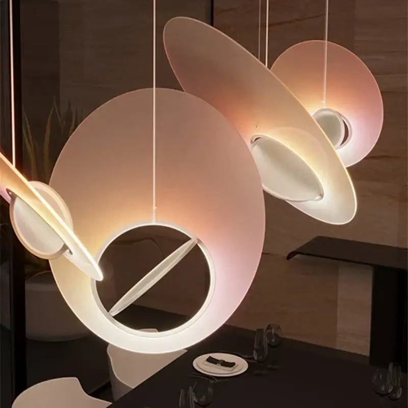 Modern pink and white oval glass pendant light with translucent warm-toned shades for dining room decorbites colorful pendant