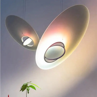 Modern pink and white oval glass pendant light with matte finish and circular cutouts for dining room decorbites colorful pendant