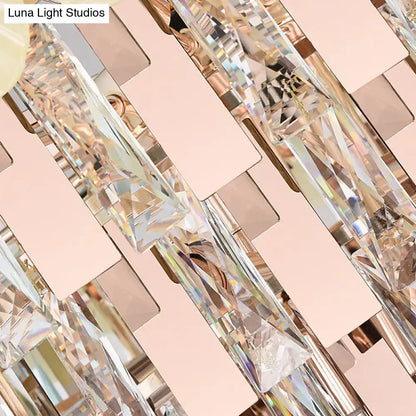 Modern pink and yellow clear crystal chandelier with faceted prisms and rose gold accents for dining room pendant lighting