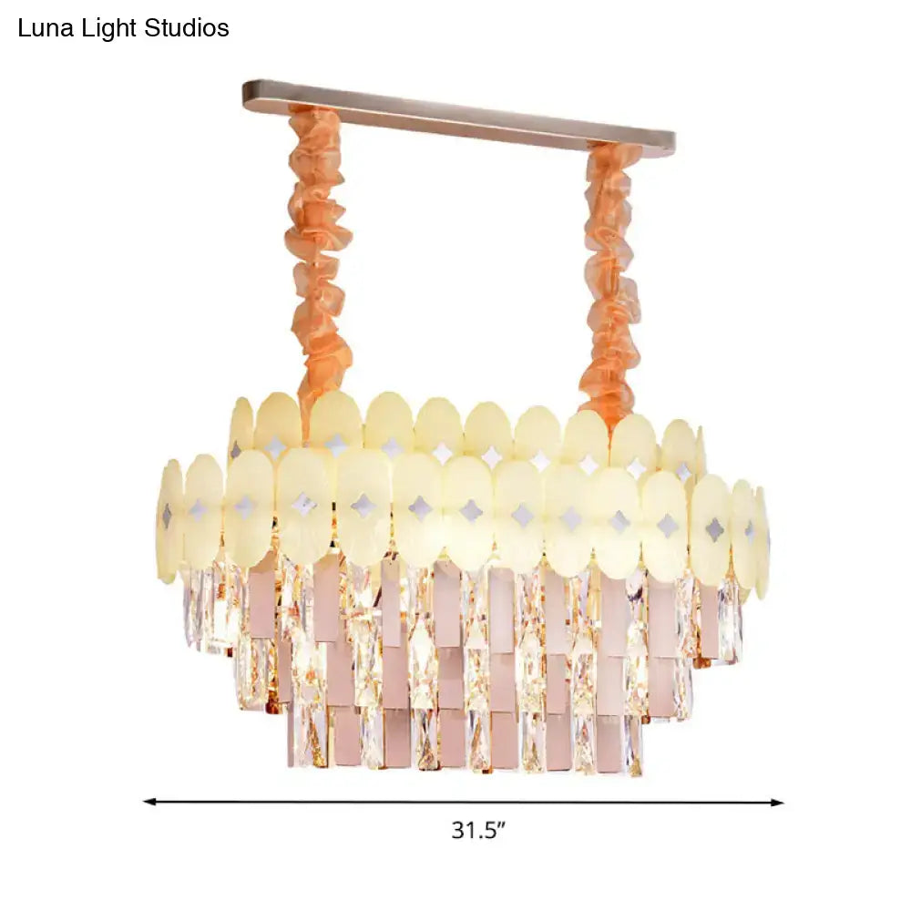 A modern pink and yellow clear crystal chandelier with rose gold metal frame for dining room pendant lighting