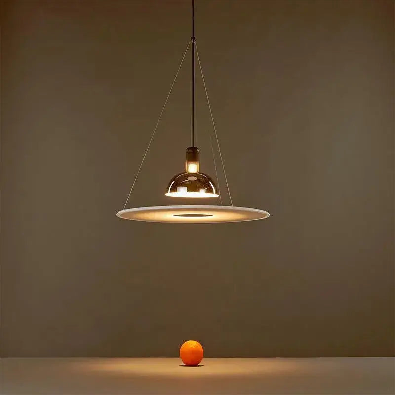 Modern polished brass and white flying saucer chandelier with warm glass shade and thin metallic wires decorbites flying saucer
