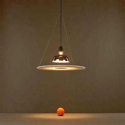 Modern polished brass and white flying saucer chandelier with warm glass shade and thin metallic wires decorbites flying saucer