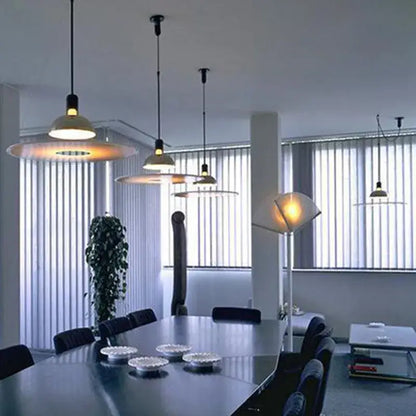 Modern polished brass and white flying saucer chandelier with warm circular shades hanging from black cords decorbites flying saucer