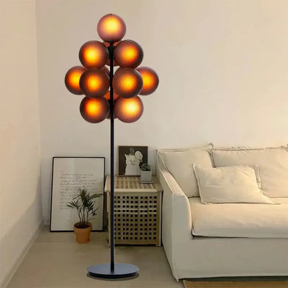 Modern purple decorbites glass bubble floor lamp with slender black metal stand and amber glass spheres for living room