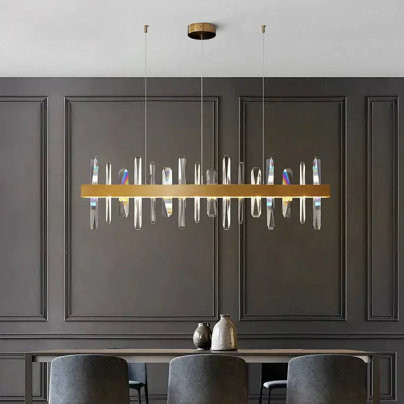 Modern rectangle gold chandelier with clear crystal prisms hanging from ceiling mount by DecorBites™