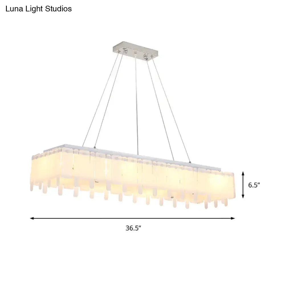 Modern rectangular chandelier with sleek chrome finish and frosted glass shades featuring adjustable hanging cord