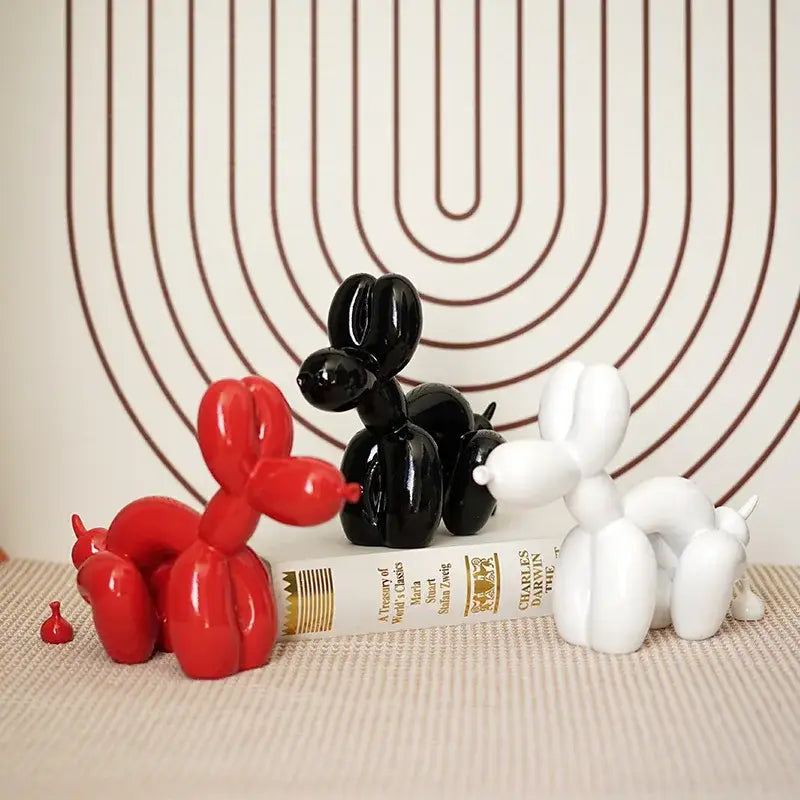 Three glossy balloon dog sculptures in red black and white modern decor for living room display