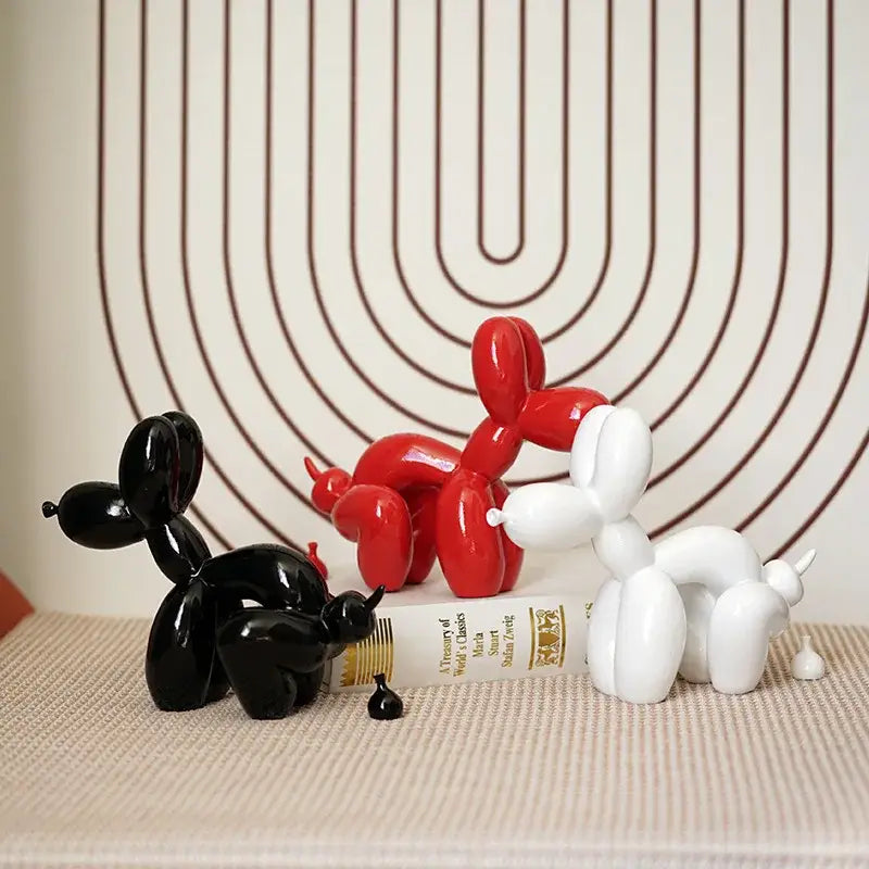 Three glossy balloon dog sculpture figurines in red black and white modern living room decor