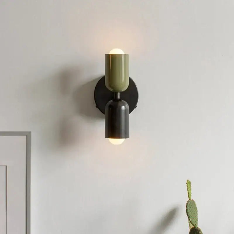 Modern two-toned led wall lamp with matte olive and black cylindrical shades for bedroom and living room decor
