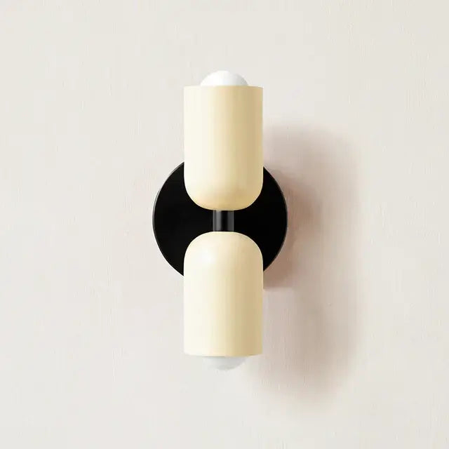 Cream-colored cylindrical led wall lamp with black base and rod for modern bedroom and living room decor lighting