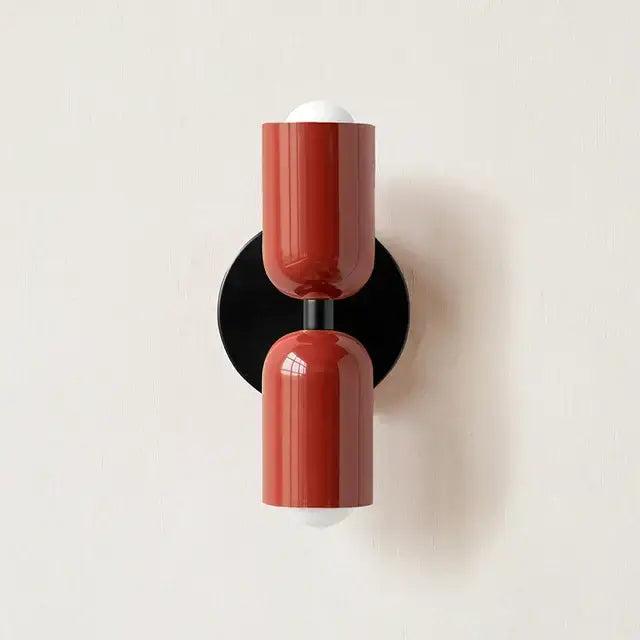 Modern red and black glossy led wall lamp with cylindrical red sconce and white bulb caps for bedroom decor