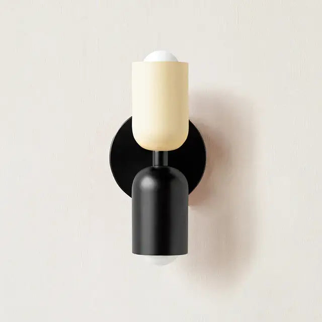 Modern cream-colored cylindrical led wall lamp with black base and circular backplate for bedroom living room decor