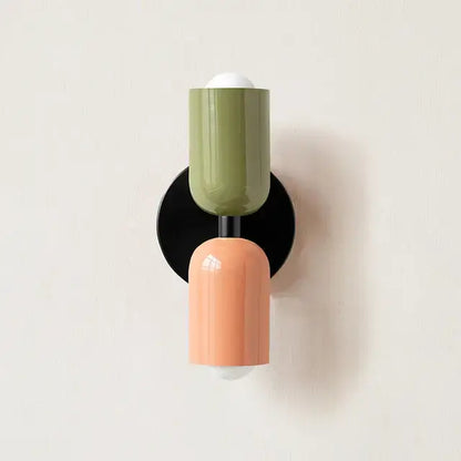 Modern red and black glossy led wall lamp with olive and peach cylindrical sconce and black base for living room decor