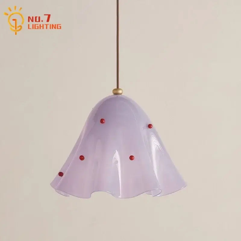 A delicate lavender glass pendant light with a fluted bell shade and red beads perfect for modern dining rooms