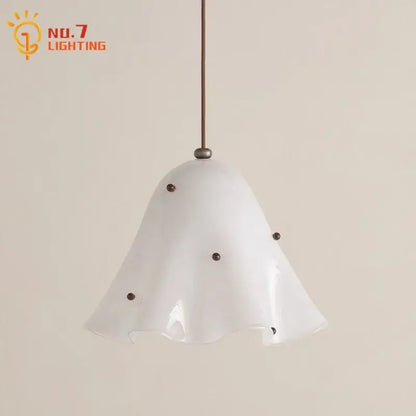Modern white frosted glass pendant light with fluted bell-shaped shade and dark metal accents for dining room use