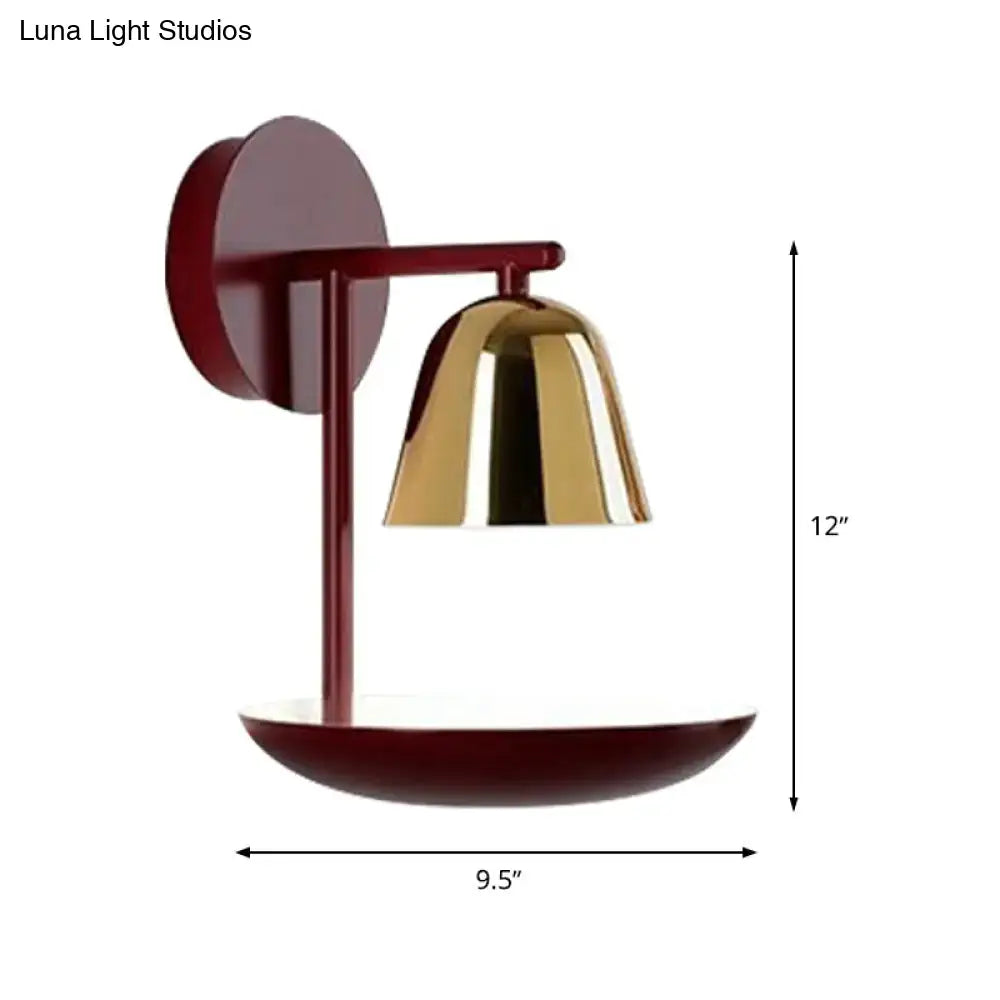 Modern wall light with a matte burgundy circular backplate and polished brass red dome wall sconce for bedroom use