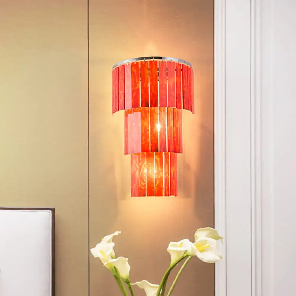 Modern red prism wall mounted light with vibrant tiered glass and sleek chrome rim for living room use