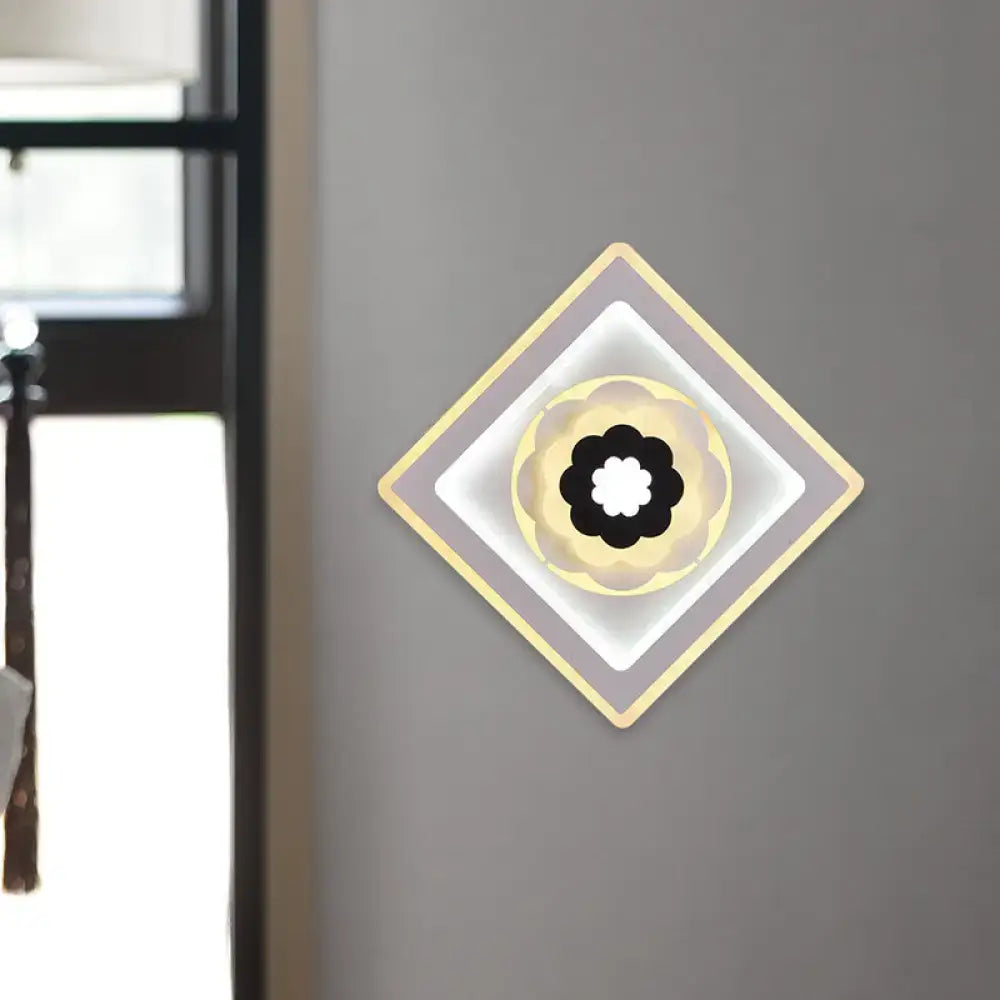 Modern rhombus bloom pattern sconce light with layered concentric rings in gray cream gold tones and black and white bulb base