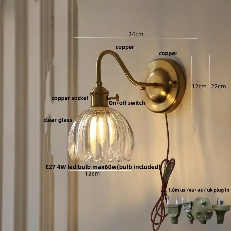 Antique brass-finished copper led wall sconce with clear ribbed glass shade for modern bedroom lighting