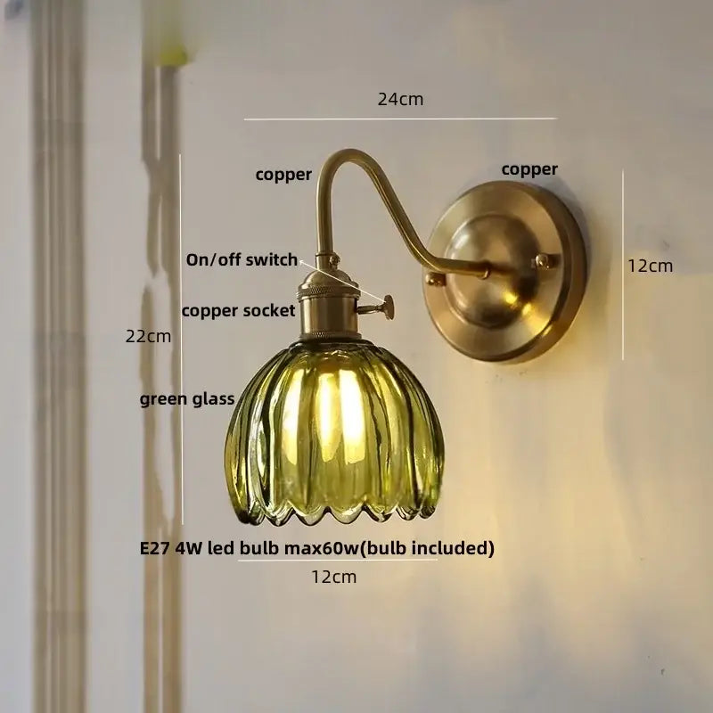 A vintage-style wall sconce with a brass copper finish, ribbed green glass shade, and glass copper knob switch