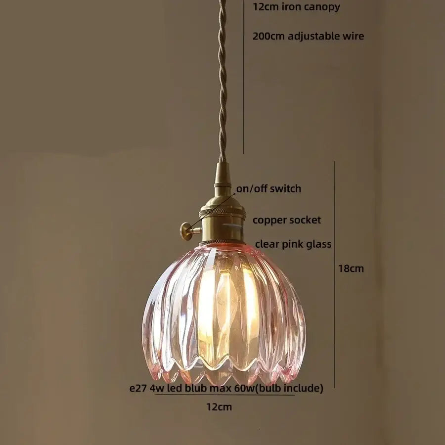 Modern pendant light featuring a delicate ribbed pink glass shade with brass fittings ideal for dining room decorbites blue glass