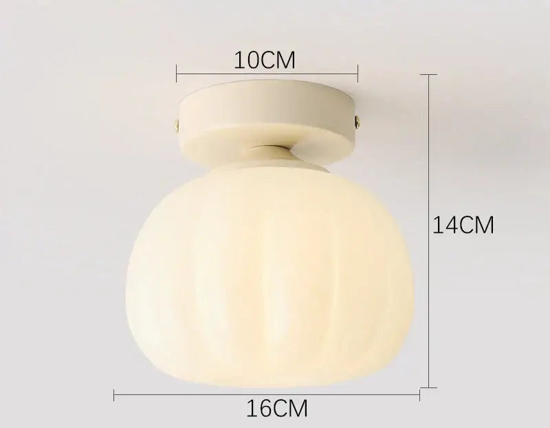 Cream-colored frosted decorbites ceramic glass chandelier with rounded ribbed globe and brass ceiling mount for living rooms